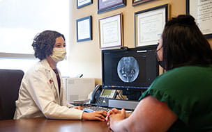 Fertility doctor talking to patient in office