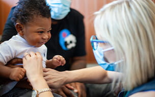 Pediatrician examining infant