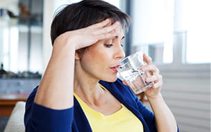 Woman drinking with hot flashes