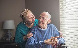 Wife taking care of husband with Parkinson's Disease