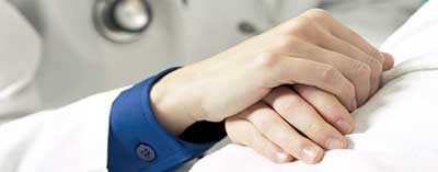 UH Elyria-nurse staffing-nurse holding patient hand
