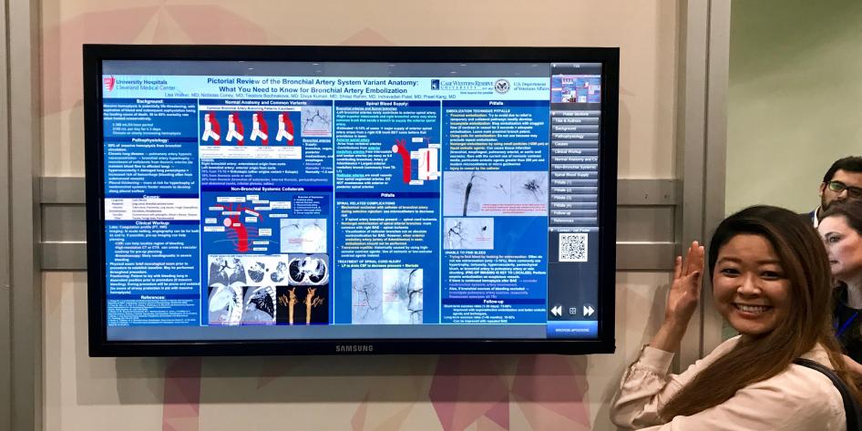 TV with electronic medical education poster with women on the left pointing at the poster