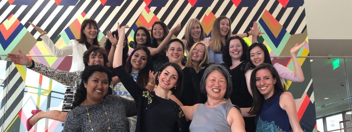 Group photo of all women in radiology with hands outstretched