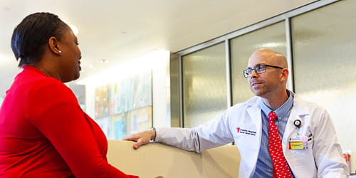 photo of patient consulting with a UH provider