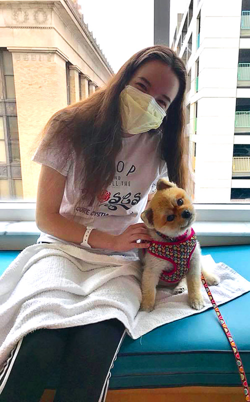 A young female patient visits with a Pet Pals dog