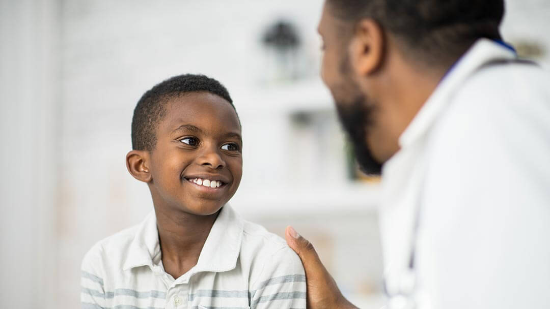 African American physician with child