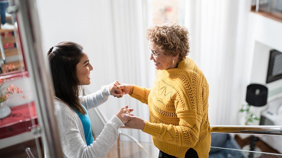 therapist assisting elderly woman