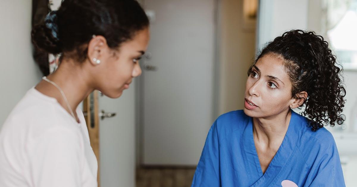 physician talking with woman