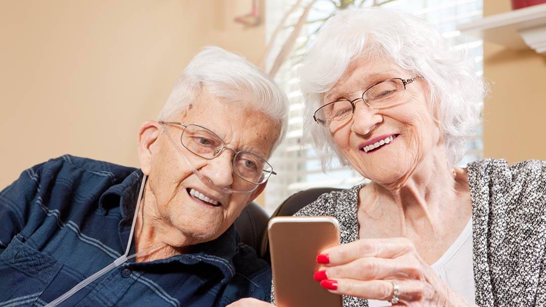 elder couple on cell phone