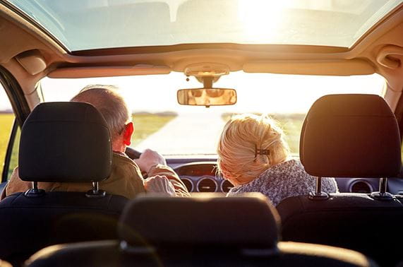 older couple in car on the open  road