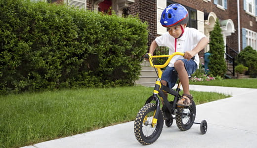 Child riding his bike.