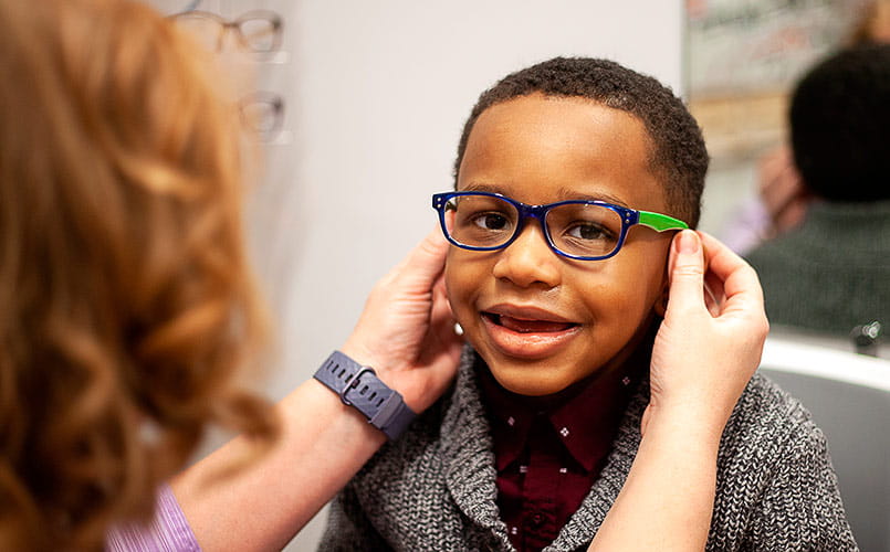 A young patient is fitted for new glasses at UH Rainbow Ahuja Center for Women & Children