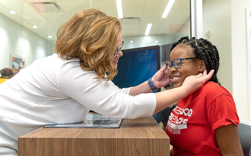A young female patient is happy with her new glasses