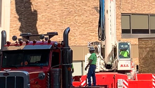 A crane lifted MRI and CT machines into the facility through the roof