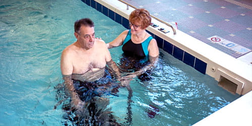 Elderly man in physical therapy in the water