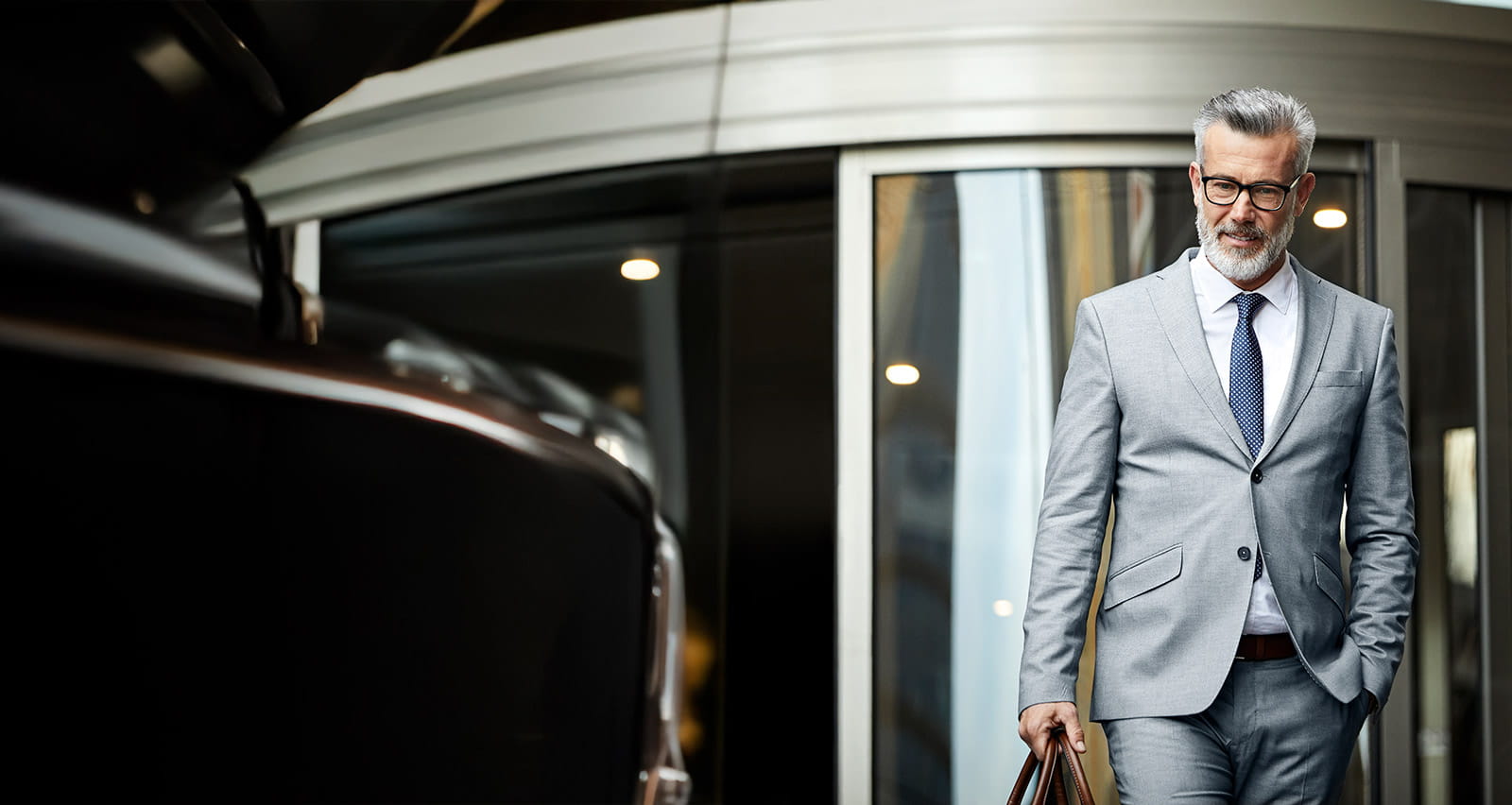 A mature businessman leaving an office building