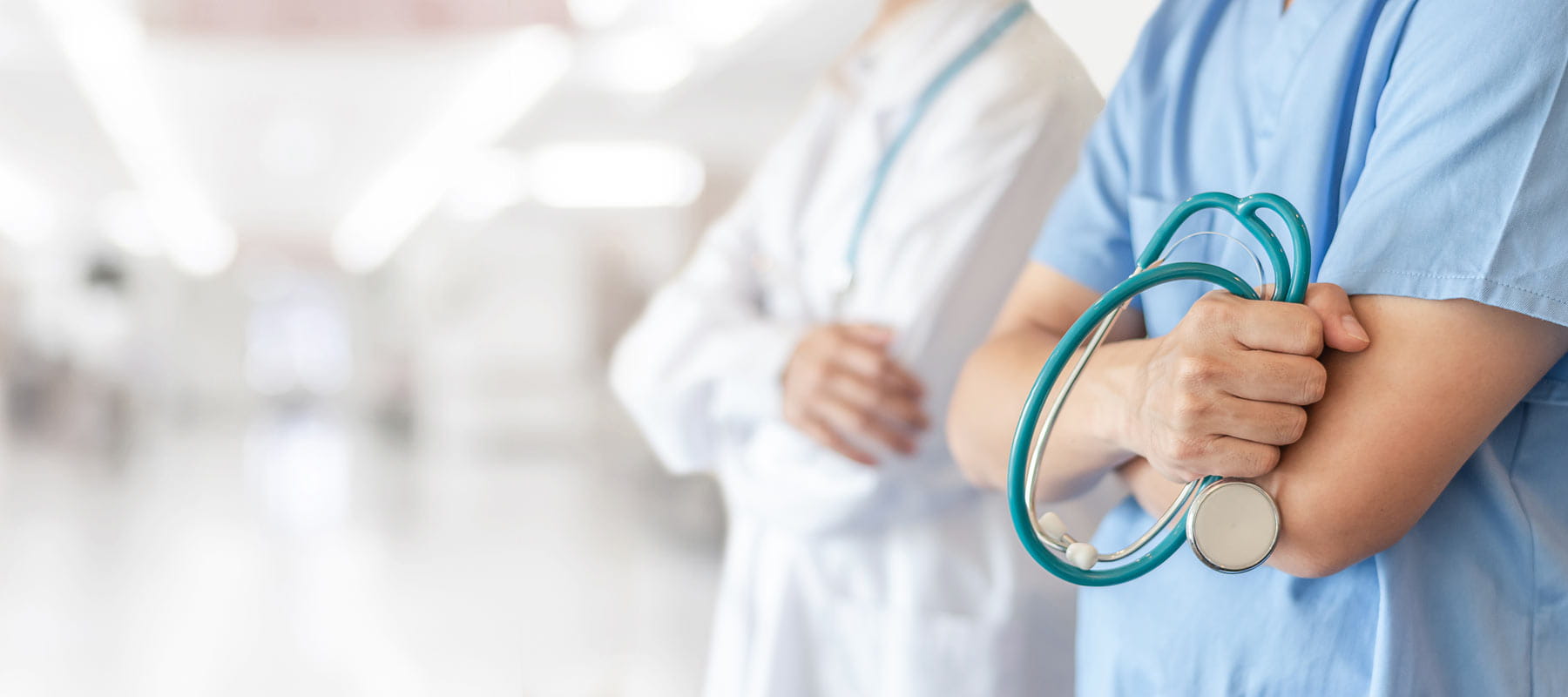 Nursing team standing outside medical clinic room