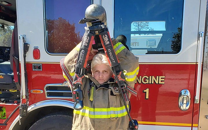 Ellita Vedder stands in front of a fire engine