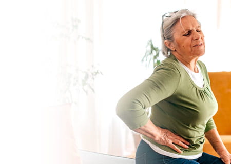 A woman in pain clutching her side