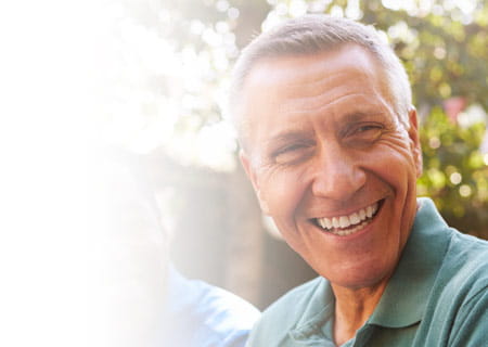 A group of mature male friends socializing in backyard together