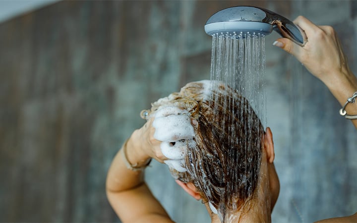 Back view of a woman washing her hair