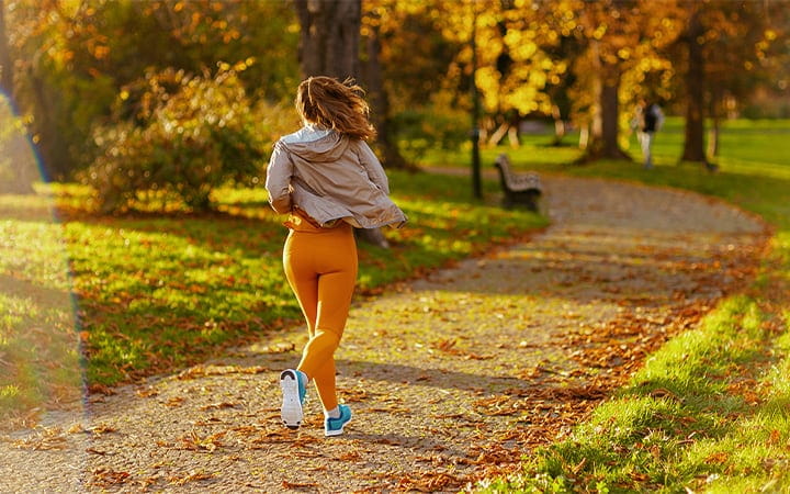 woman jogging outdoors in the fall