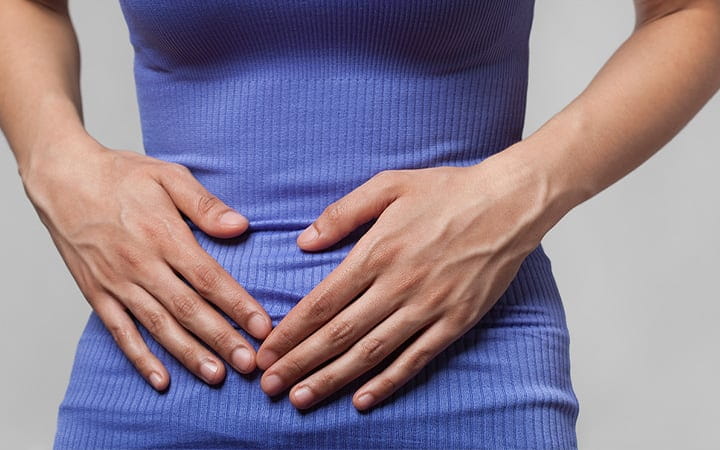 Close-up view of a woman experiencing pain or cramps in her stomach