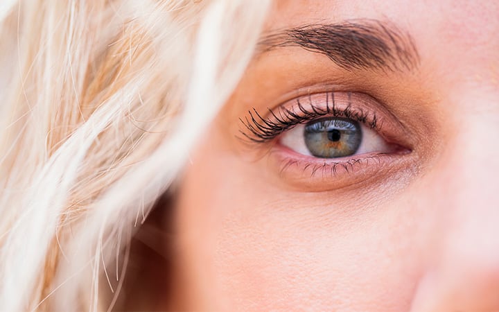 A woman with light eyes staring at the camera