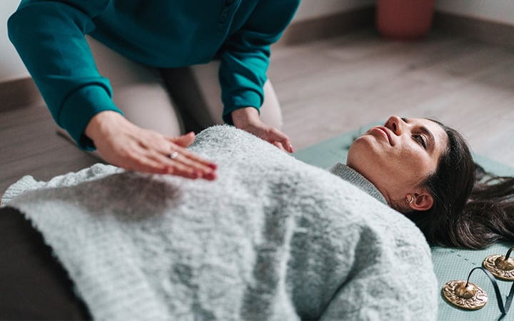 A woman receiving reiki healing therapy for relaxation