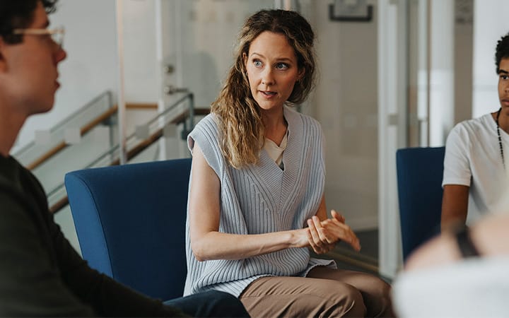 A female mental health professional giving advice to a small group
