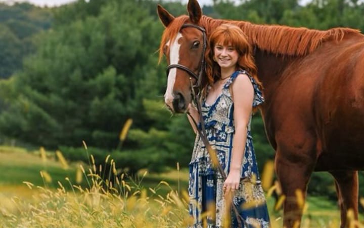 Periacetabular osteotomy (PAO) surgery patient McKenna stands outside with her horse
