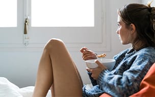 woman eating bowl of cereal