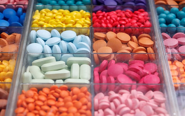 Plastic bins containing various pills