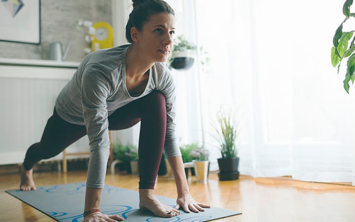 Woman practicing yoga at home
