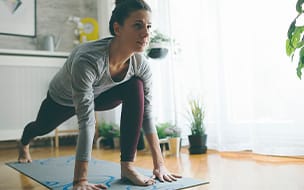 Woman practicing yoga at home