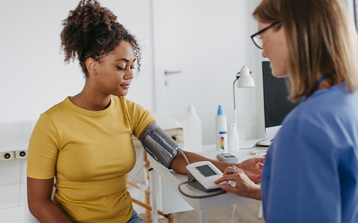 A doctor measuring a patient’s blood pressure