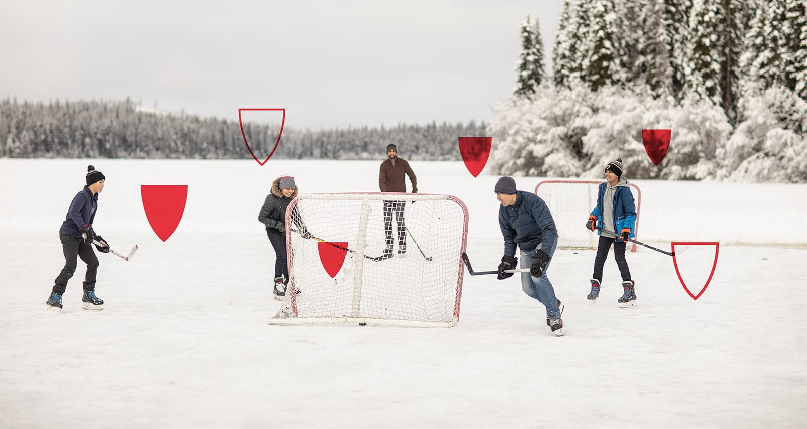 A group of happy people playing ice hockey outdoors