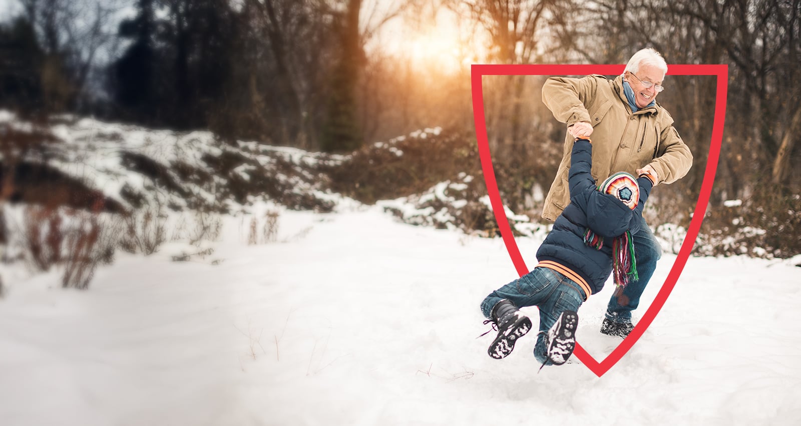 A grandfather and grandson playing in the snow