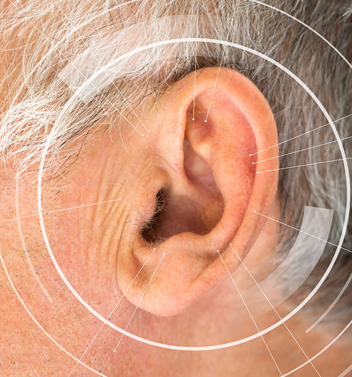 Human ear with sound waves depicting Acquired hearing loss.