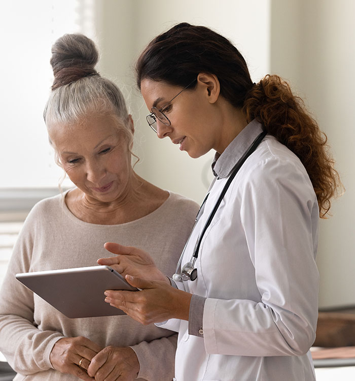 Clinician talking to a woman of menopausal age.
