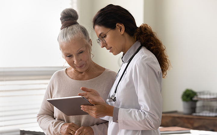 Clinician talking to a woman of menopausal age.
