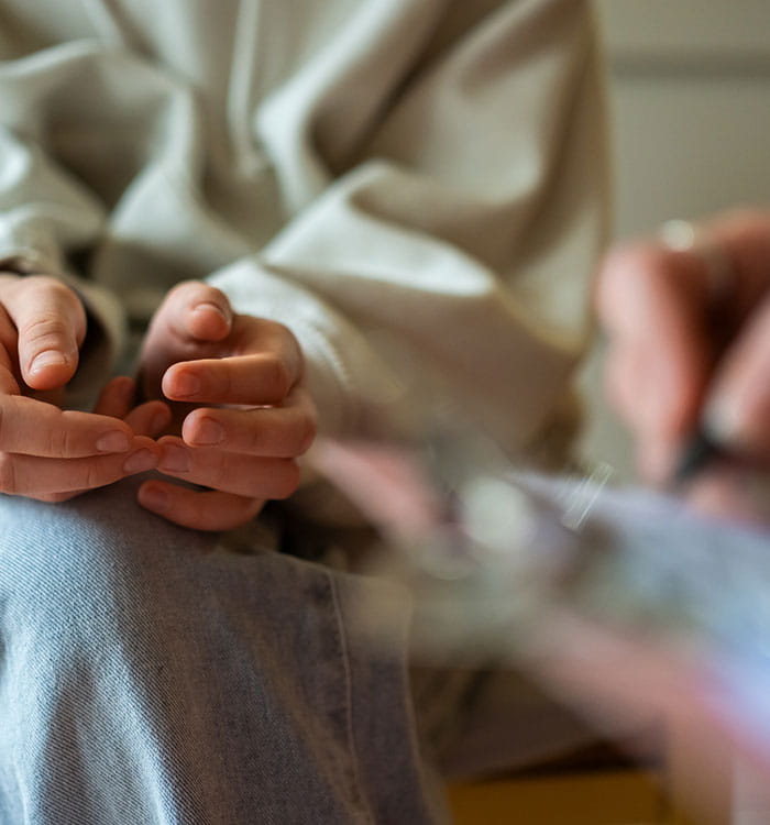 Close-up of therapy session with anxious teenage girl.