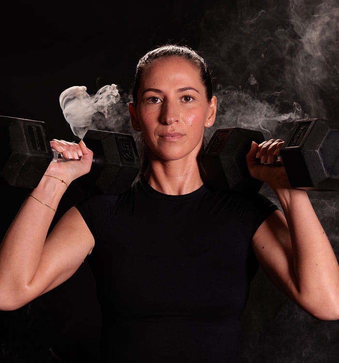 Female athlete lifting weights.