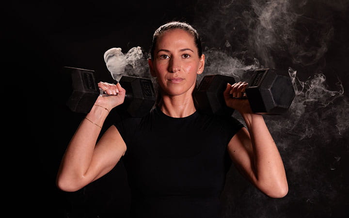 Female athlete lifting weights.
