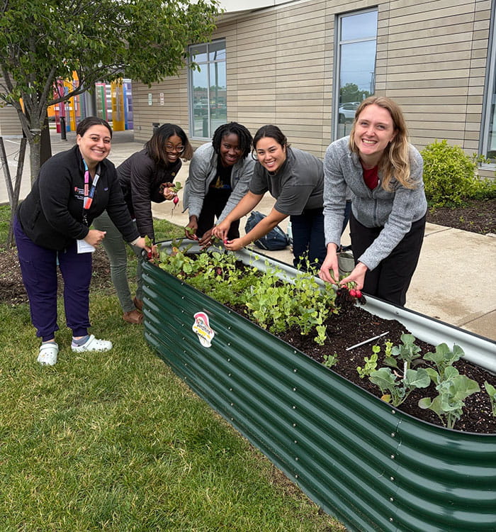 UH Rainbow pediatric residents in front of the raised garden.