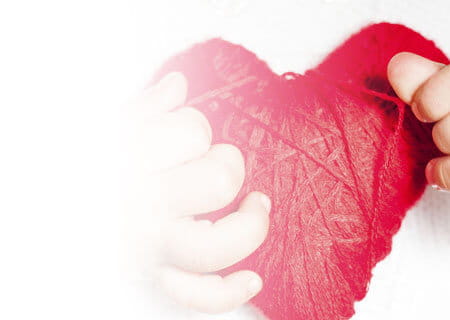 child holding heart pillow