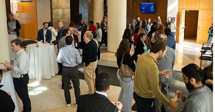 UH Research and Education State of Research program reception guests in foyer.