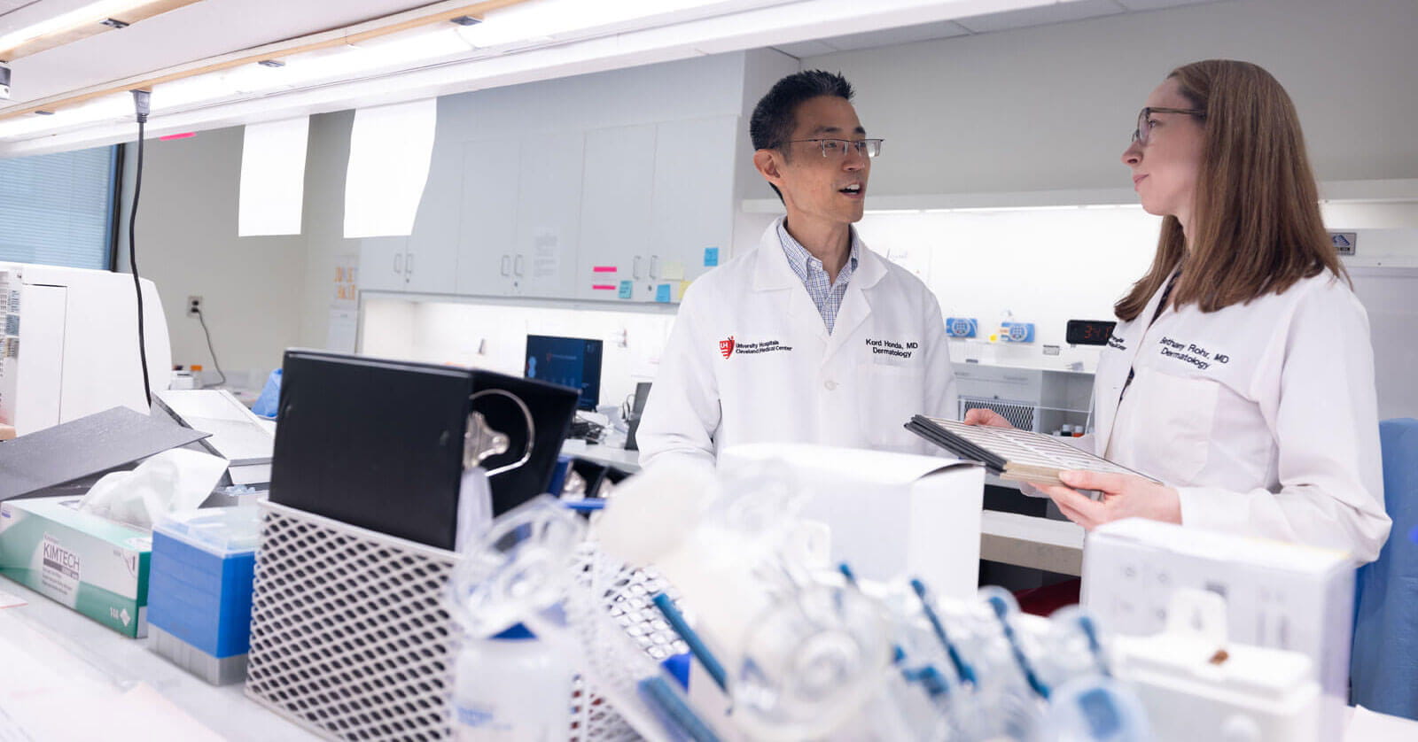 dermatology physician having a conversation in a lab
