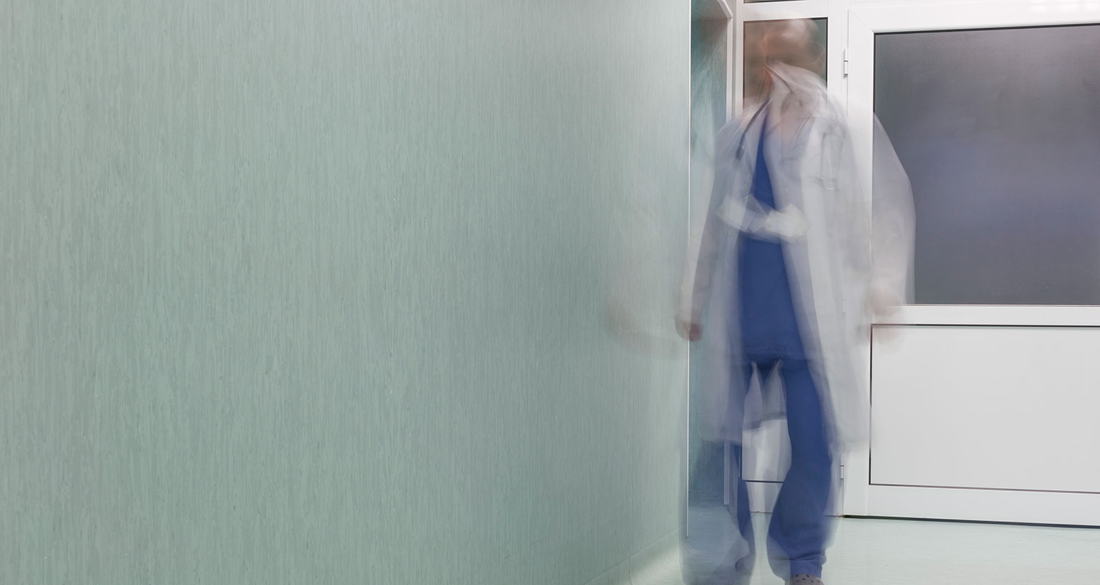A provider walks down the hallway