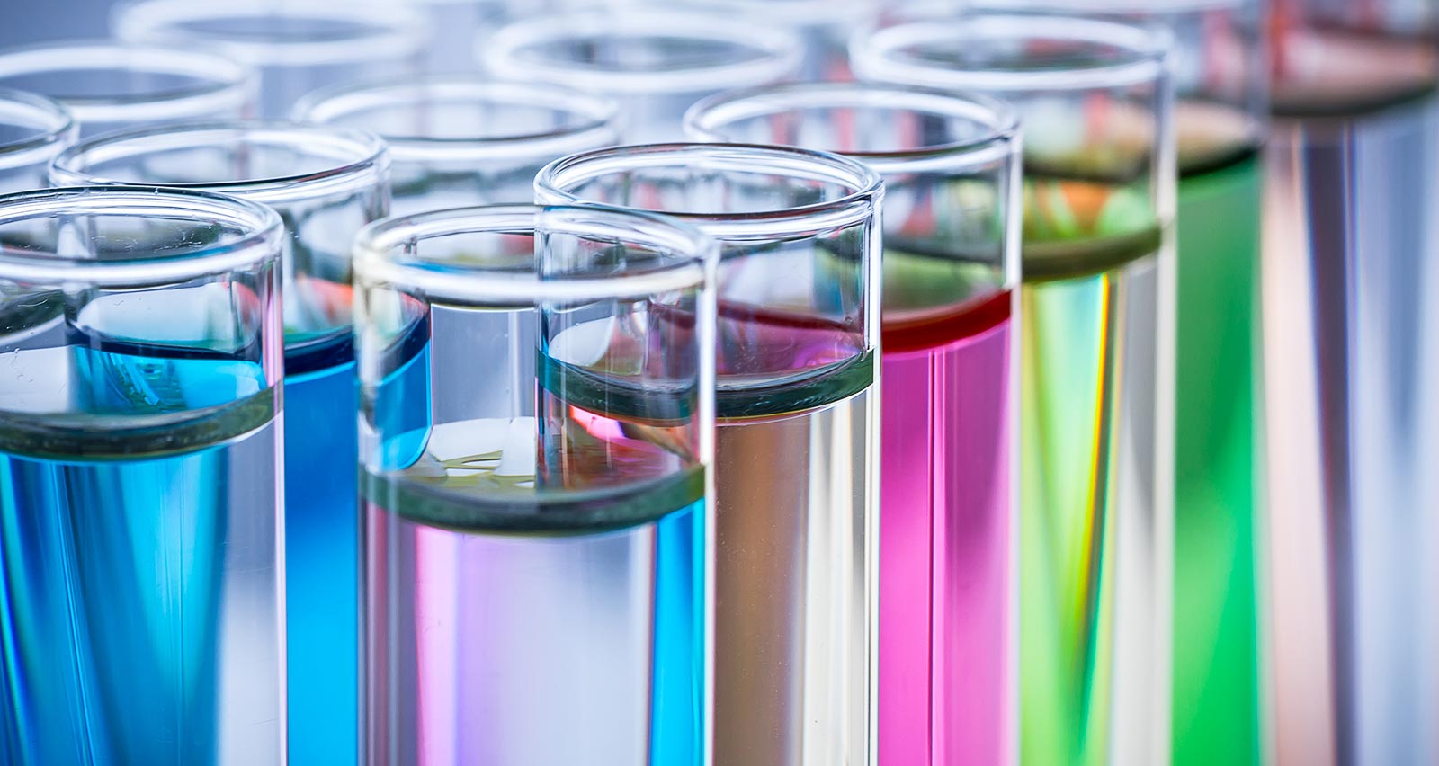 A rack of test tubes containing colorful liquids
